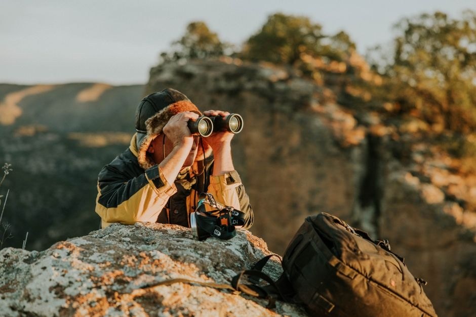 A traveler using a camera during an outdoor walk.
